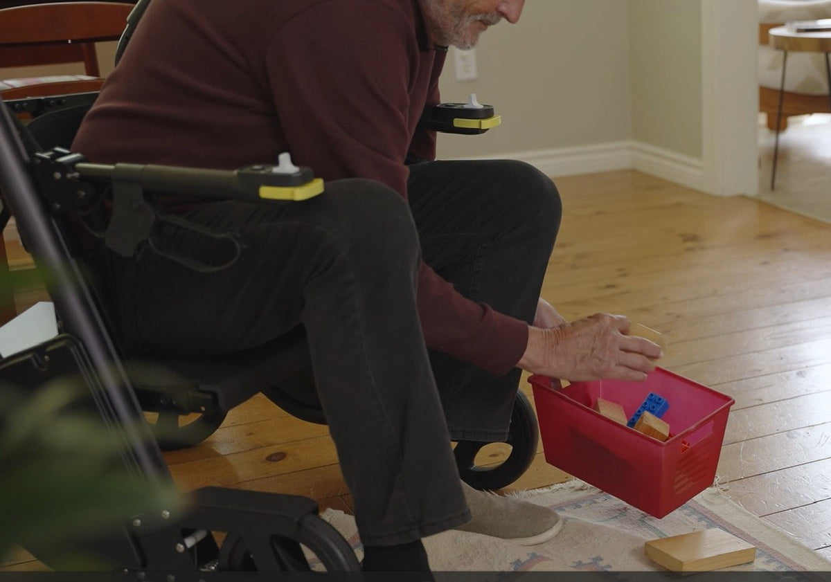 Lowered RAYMEX Lift Quattro seat lets a user reach floor level without bending or kneeling