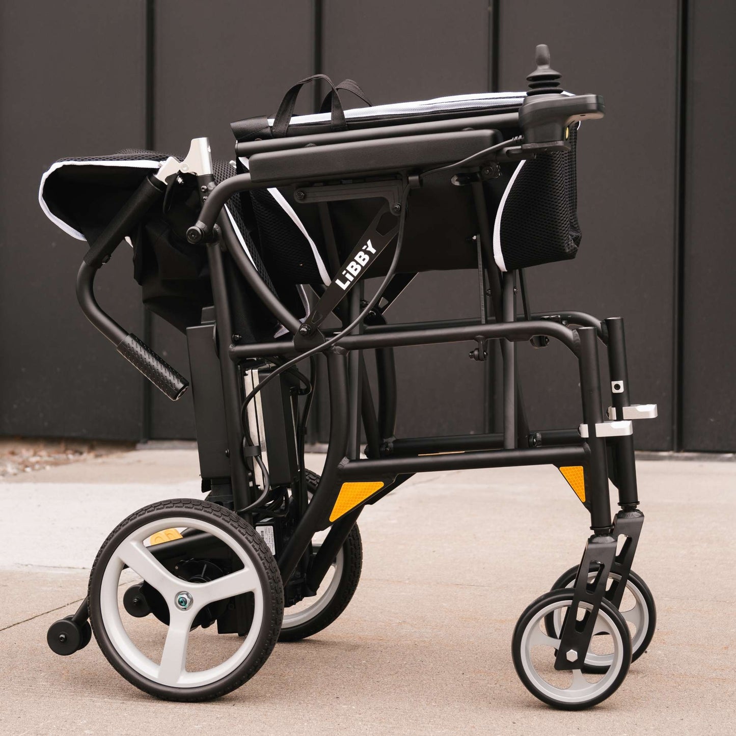 Close-up of the LIBBY branding on the power wheelchair frame