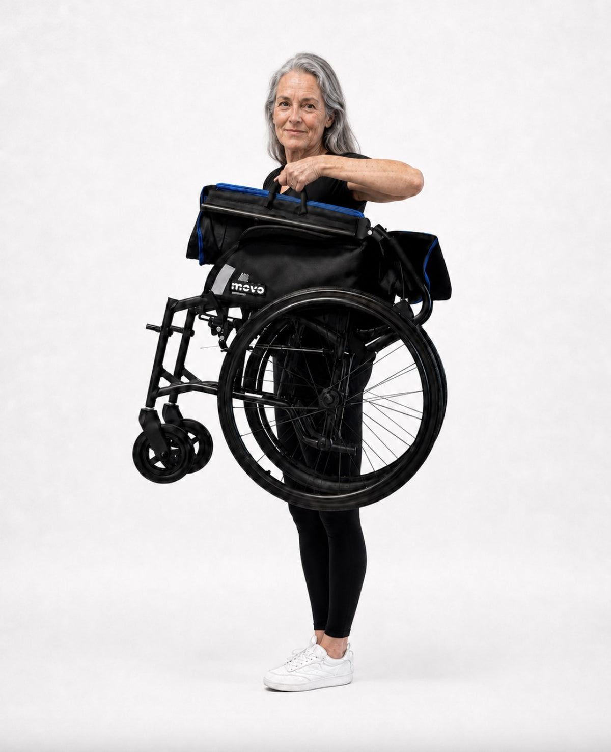 Woman carrying the folded 23 lb Movo M3 Lite wheelchair one-handed