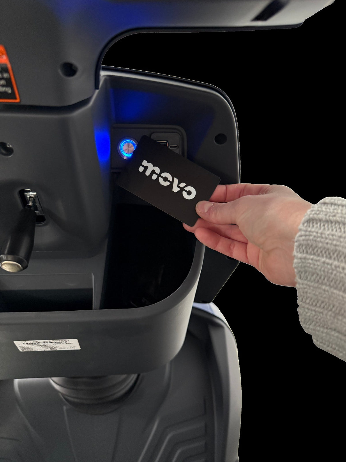 Contactless key card being held to the Movo MACH to start the scooter