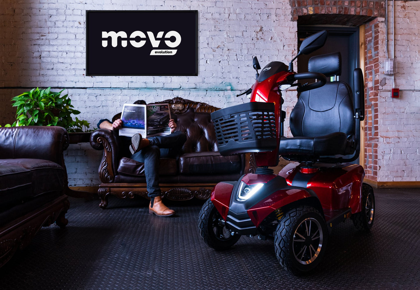 Red Movo Sutton mobility scooter indoors at a Movo showroom