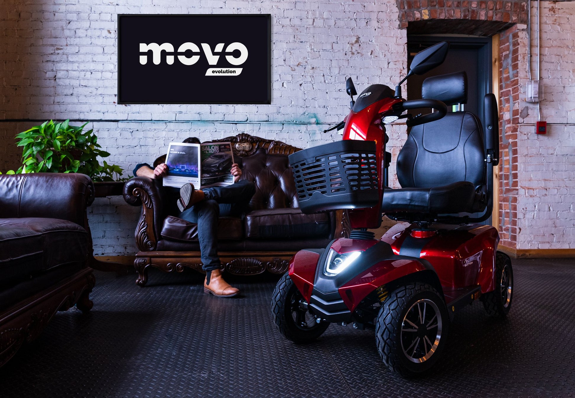 Red Movo Sutton mobility scooter indoors at a Movo showroom