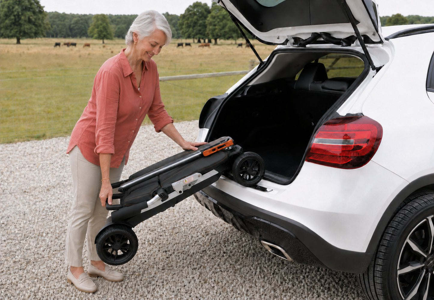 Movo Pilot folded flat and lying in a car boot leaving luggage space