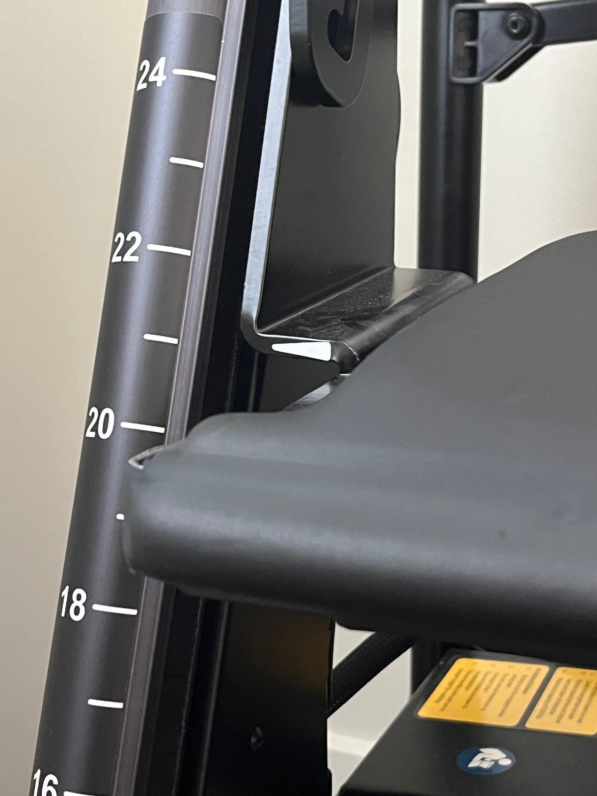 Close-up of the RAYMEX Lift Quattro seat-height scale marked in inches for graded sit-to-stand rehab