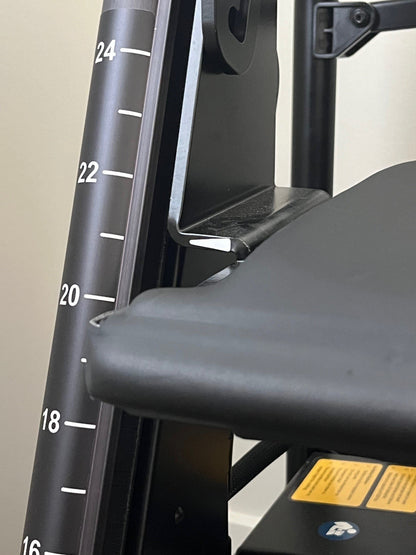 Close-up of the RAYMEX Lift Quattro seat-height scale marked in inches for graded sit-to-stand rehab
