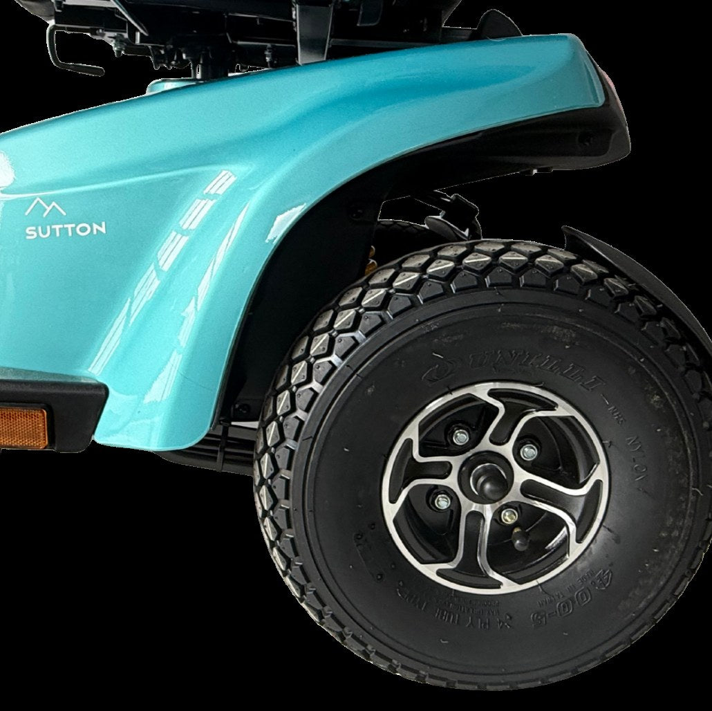 Close-up of the Movo Sutton front body panel, badge and all-terrain tyre