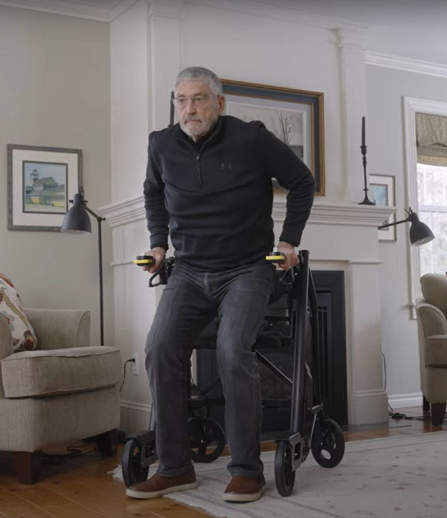 Man rising to a full standing position from the RAYMEX Lift Standard elevating seat